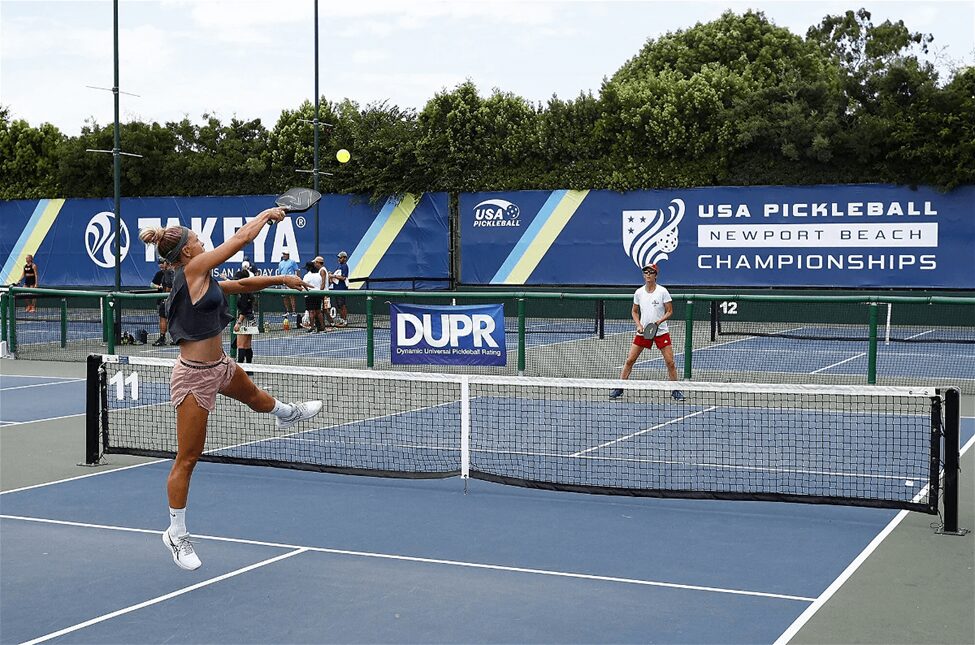 On the court, two players play pickleball 