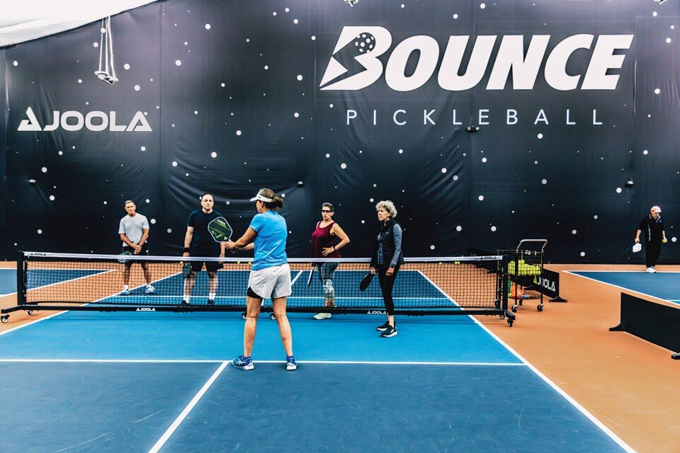 Professionals demonstrate their pickleball skills to beginners 